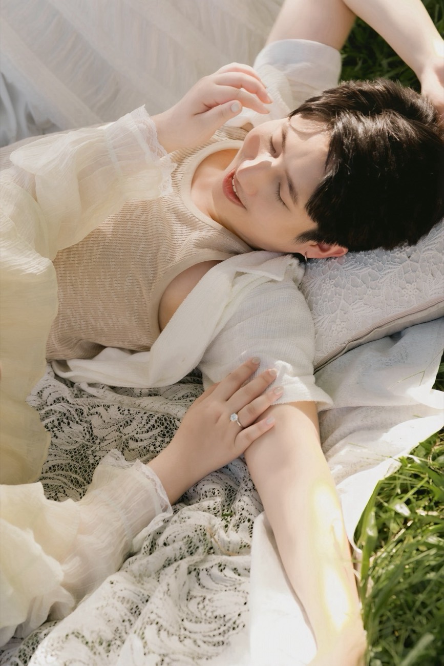 Couple resting close together, hands and lace in soft light