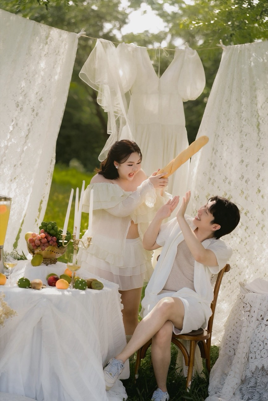 Bride and groom laughing at a garden table setting